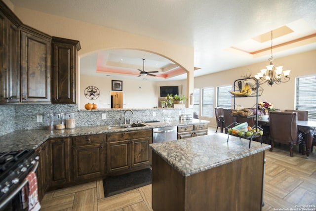 2989 Graytown, Converse, TX 78109 - kitchen with appliances with stainless steel finishes, a sink, a raised ceiling, arched walkways, and ceiling fan with notable chandelier