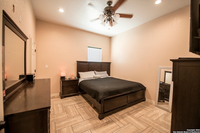 bedroom with ceiling fan and light parquet floors