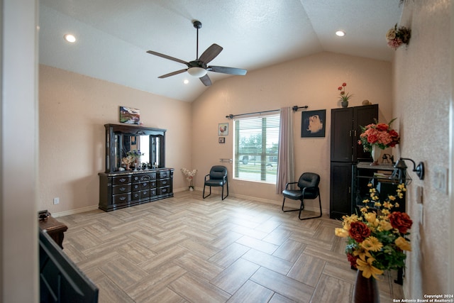 sitting room featuring light parquet floors, vaulted ceiling, and ceiling fan