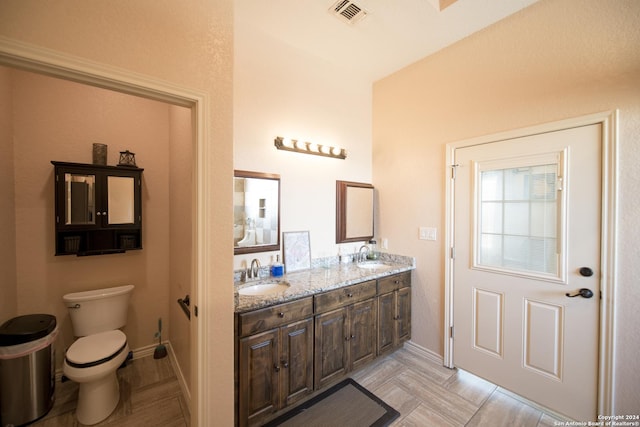 2989 Graytown, Converse, TX 78109 - bathroom with a sink, double vanity, toilet, baseboards, and visible vents