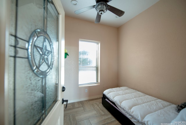 bedroom with ceiling fan and light parquet flooring