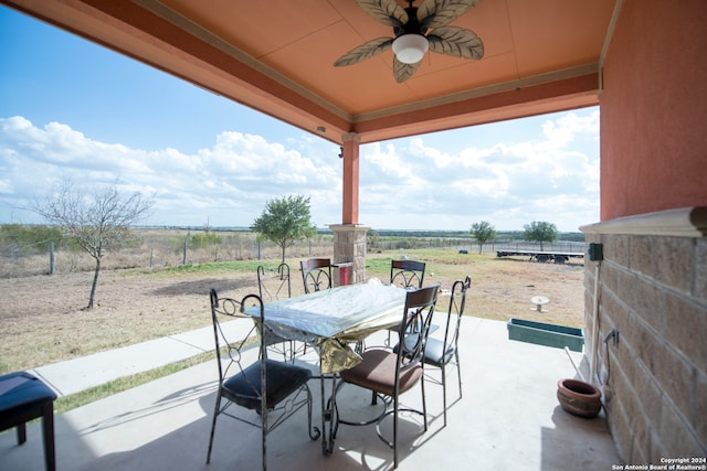 view of patio featuring ceiling fan and a rural view