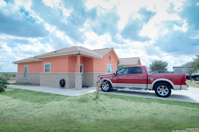 view of side of property with a yard