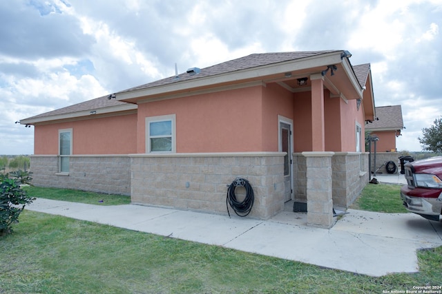 2989 Graytown, Converse, TX 78109 - view of side of property with a lawn, fence, a shingled roof, and stucco siding
