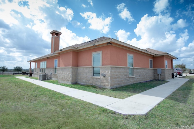2989 Graytown, Converse, TX 78109 - view of side of home with a yard, a chimney, cooling unit, and stucco siding