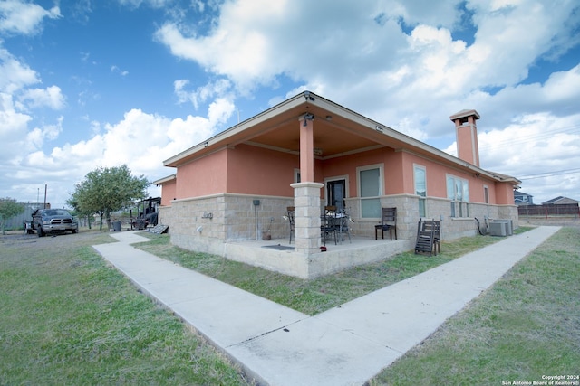 2989 Graytown, Converse, TX 78109 - exterior space with central AC, stucco siding, a front yard, and stone siding