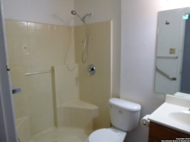 bathroom with toilet, vanity, and walk in shower