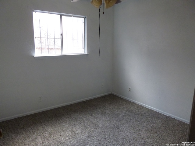 spare room featuring ceiling fan and carpet floors