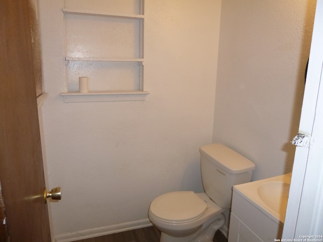 bathroom featuring wood-type flooring, vanity, and toilet