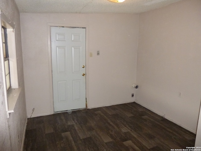 empty room featuring dark wood-type flooring