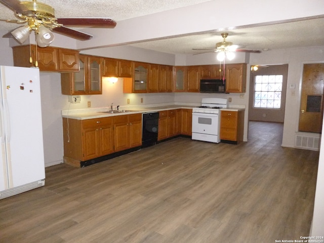 kitchen with black appliances, sink, dark hardwood / wood-style floors, ceiling fan, and a textured ceiling