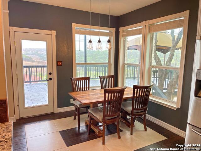 dining space featuring a healthy amount of sunlight and tile patterned flooring