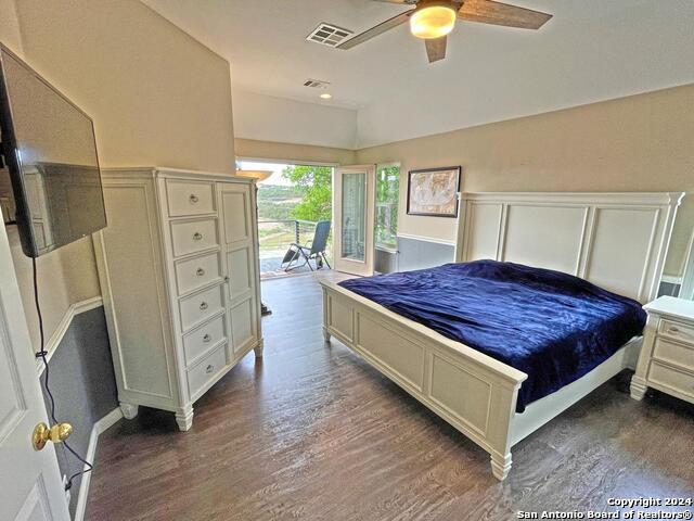 bedroom with ceiling fan and dark hardwood / wood-style flooring