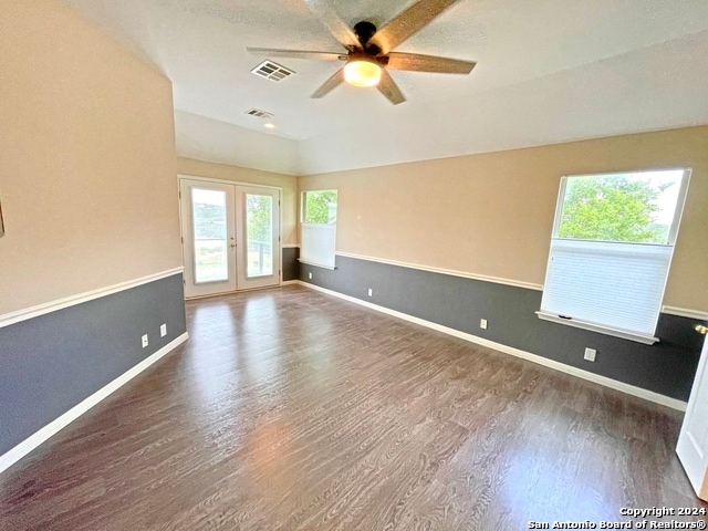 unfurnished room featuring french doors, ceiling fan, and dark hardwood / wood-style flooring