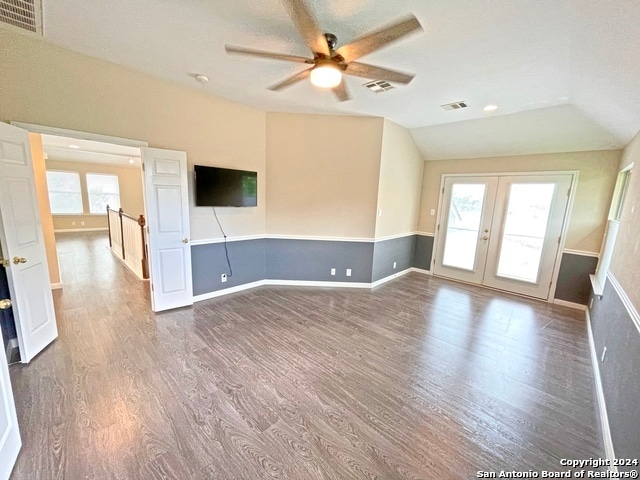 empty room featuring french doors, vaulted ceiling, wood-type flooring, and ceiling fan