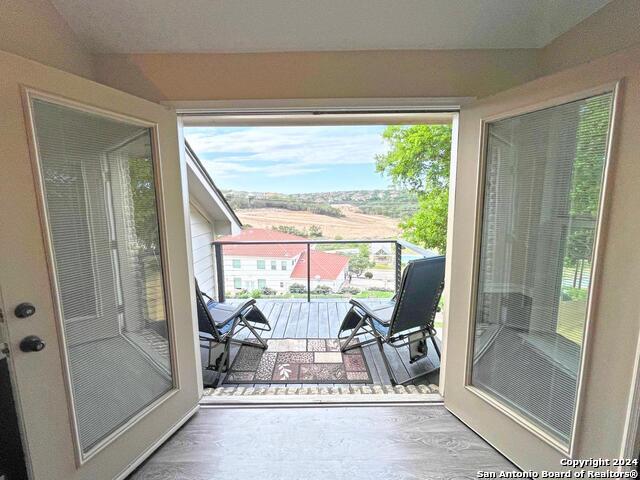 doorway with hardwood / wood-style floors