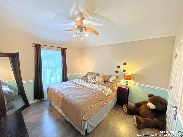 bedroom featuring hardwood / wood-style flooring and ceiling fan