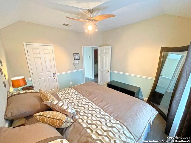 bedroom featuring lofted ceiling and ceiling fan