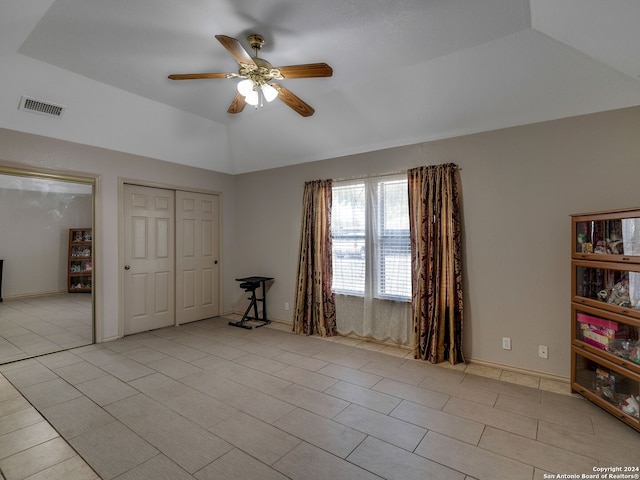 interior space with lofted ceiling, light tile patterned flooring, a closet, and ceiling fan