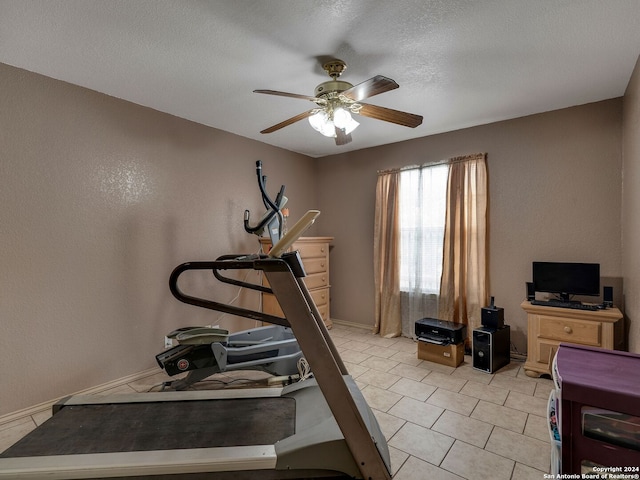 workout area featuring a textured ceiling and ceiling fan