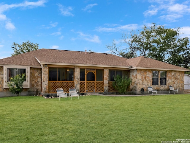 rear view of property with a lawn