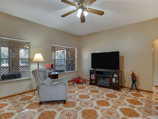 living room with light tile patterned floors, a healthy amount of sunlight, and ceiling fan