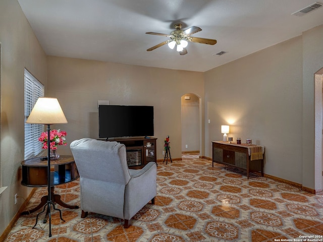 living room with light tile patterned floors and ceiling fan