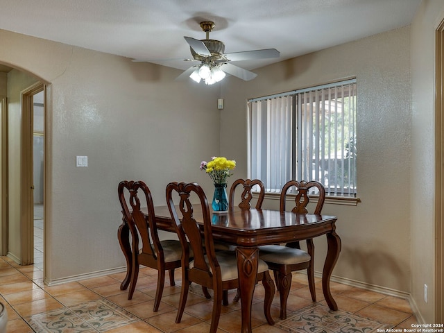 tiled dining area featuring ceiling fan