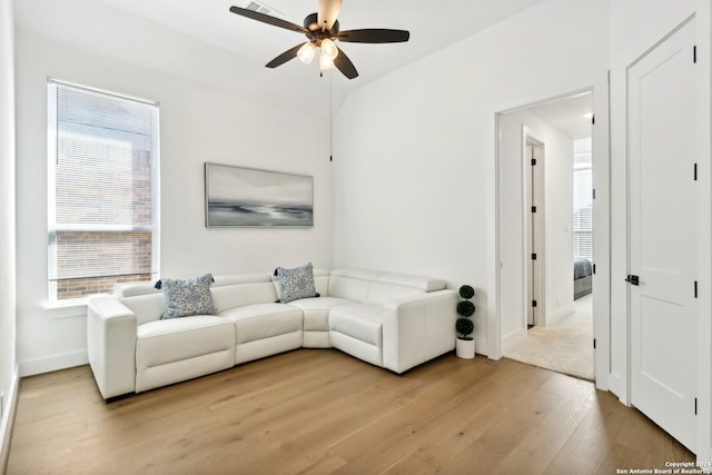 living room with light hardwood / wood-style floors, plenty of natural light, and ceiling fan