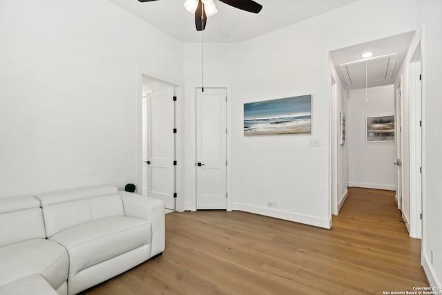 sitting room featuring light wood-type flooring and ceiling fan