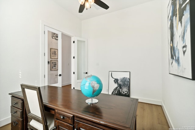 home office with french doors, light hardwood / wood-style floors, and ceiling fan