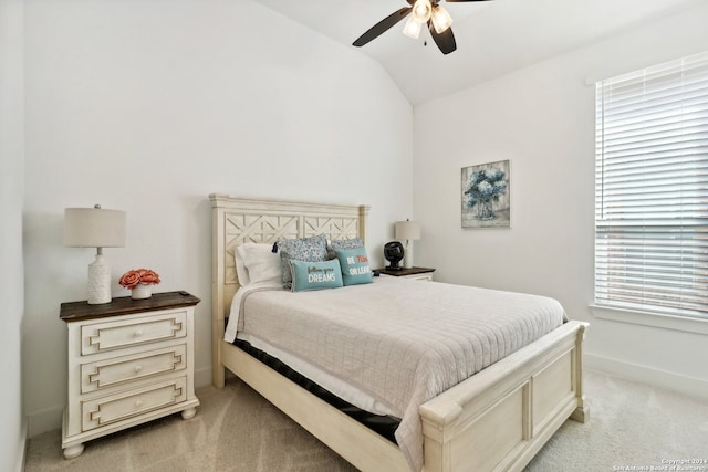 carpeted bedroom featuring vaulted ceiling, multiple windows, and ceiling fan