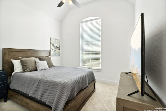 bedroom featuring lofted ceiling, light colored carpet, and ceiling fan