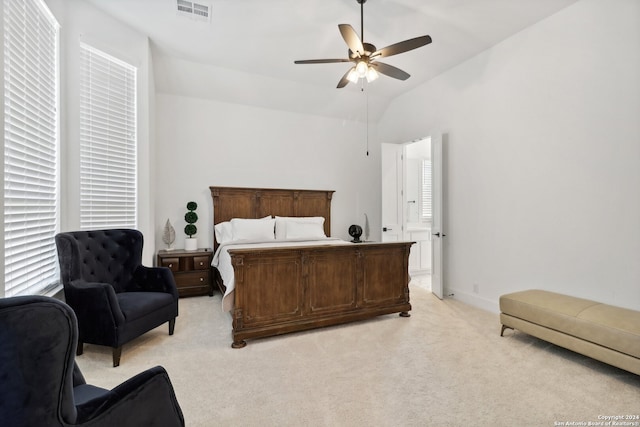 bedroom featuring light carpet, lofted ceiling, and ceiling fan