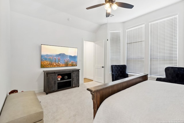 carpeted bedroom featuring ceiling fan and vaulted ceiling