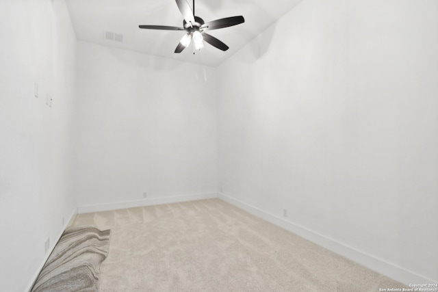 unfurnished room featuring ceiling fan, vaulted ceiling, and light colored carpet