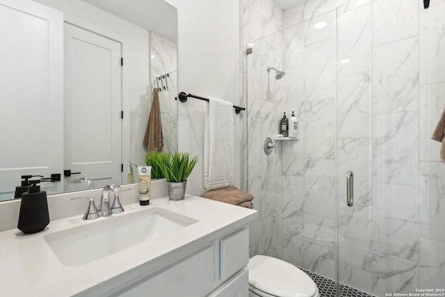 bathroom featuring vanity, walk in shower, and toilet