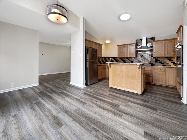 kitchen featuring wall chimney exhaust hood, dark wood-type flooring, backsplash, a center island, and appliances with stainless steel finishes