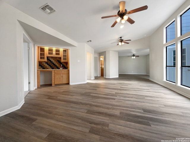 unfurnished living room featuring ceiling fan and dark hardwood / wood-style floors