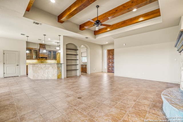 living area with arched walkways, beam ceiling, visible vents, and a ceiling fan