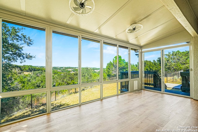 unfurnished sunroom featuring ceiling fan and lofted ceiling