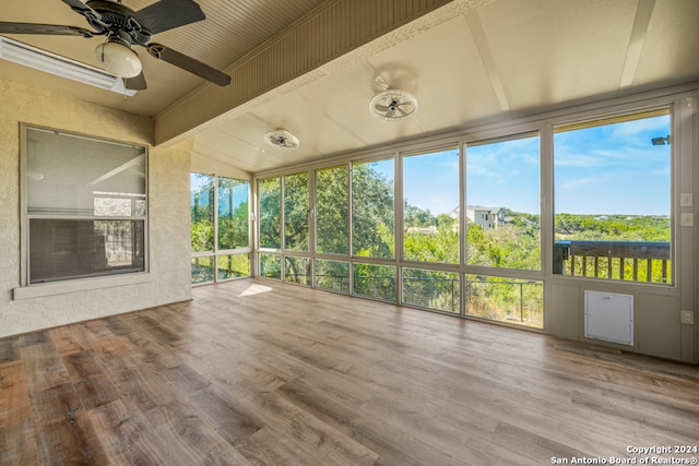 unfurnished sunroom featuring lofted ceiling with beams and ceiling fan