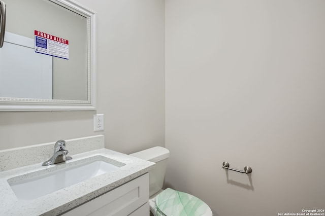 bathroom featuring toilet and vanity