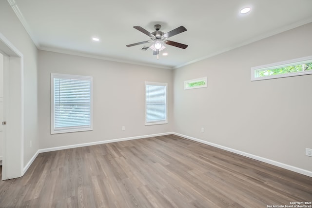 spare room with ornamental molding, light wood-type flooring, and ceiling fan