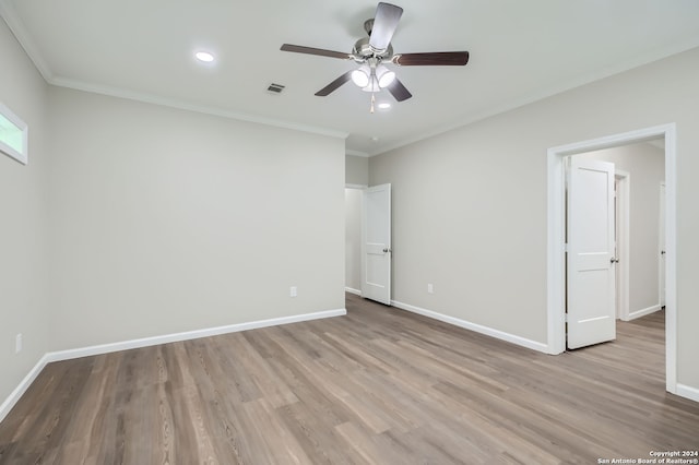 unfurnished bedroom featuring ceiling fan, crown molding, and light hardwood / wood-style floors