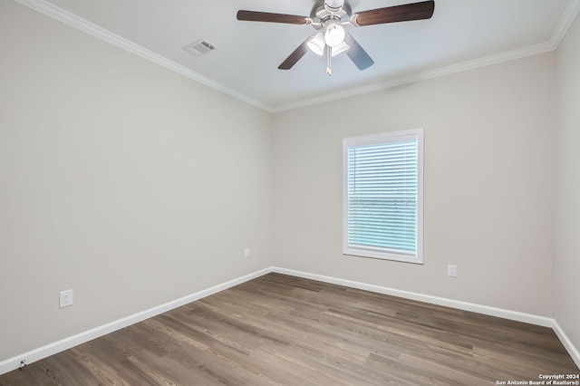 unfurnished room with baseboards, ornamental molding, wood finished floors, and a ceiling fan