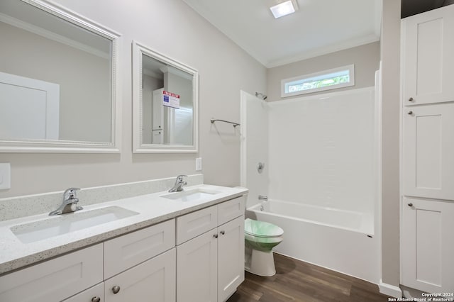 full bathroom with toilet, vanity, hardwood / wood-style flooring, ornamental molding, and tub / shower combination