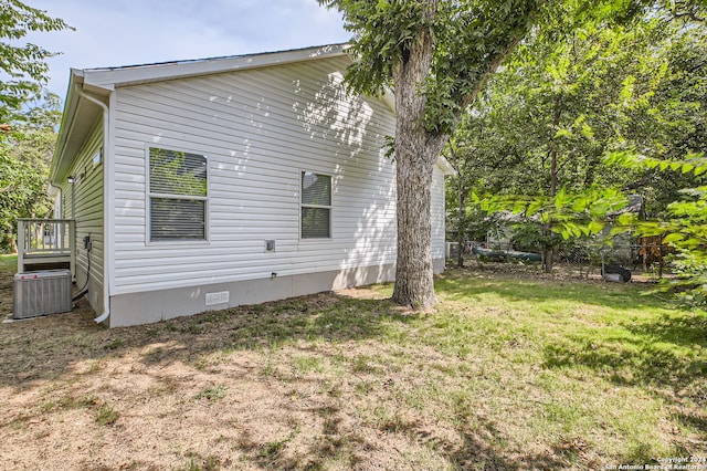 view of home's exterior featuring central AC and a yard