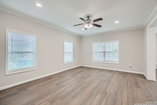 unfurnished room with light hardwood / wood-style floors, crown molding, and ceiling fan