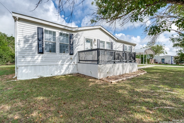 exterior space with a deck and a lawn